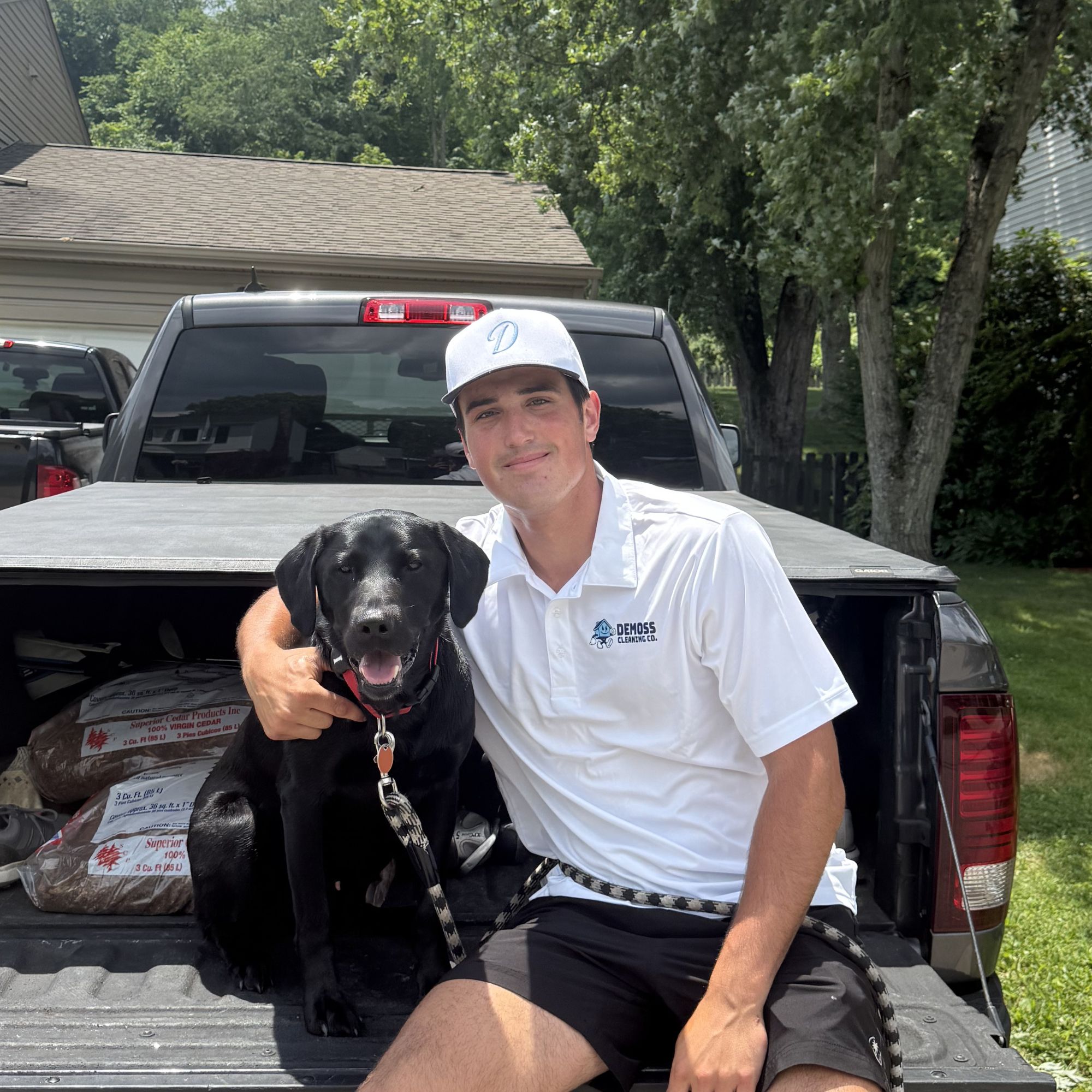 Coleman of DeMoss Cleaning Co. with his dog by the company truck