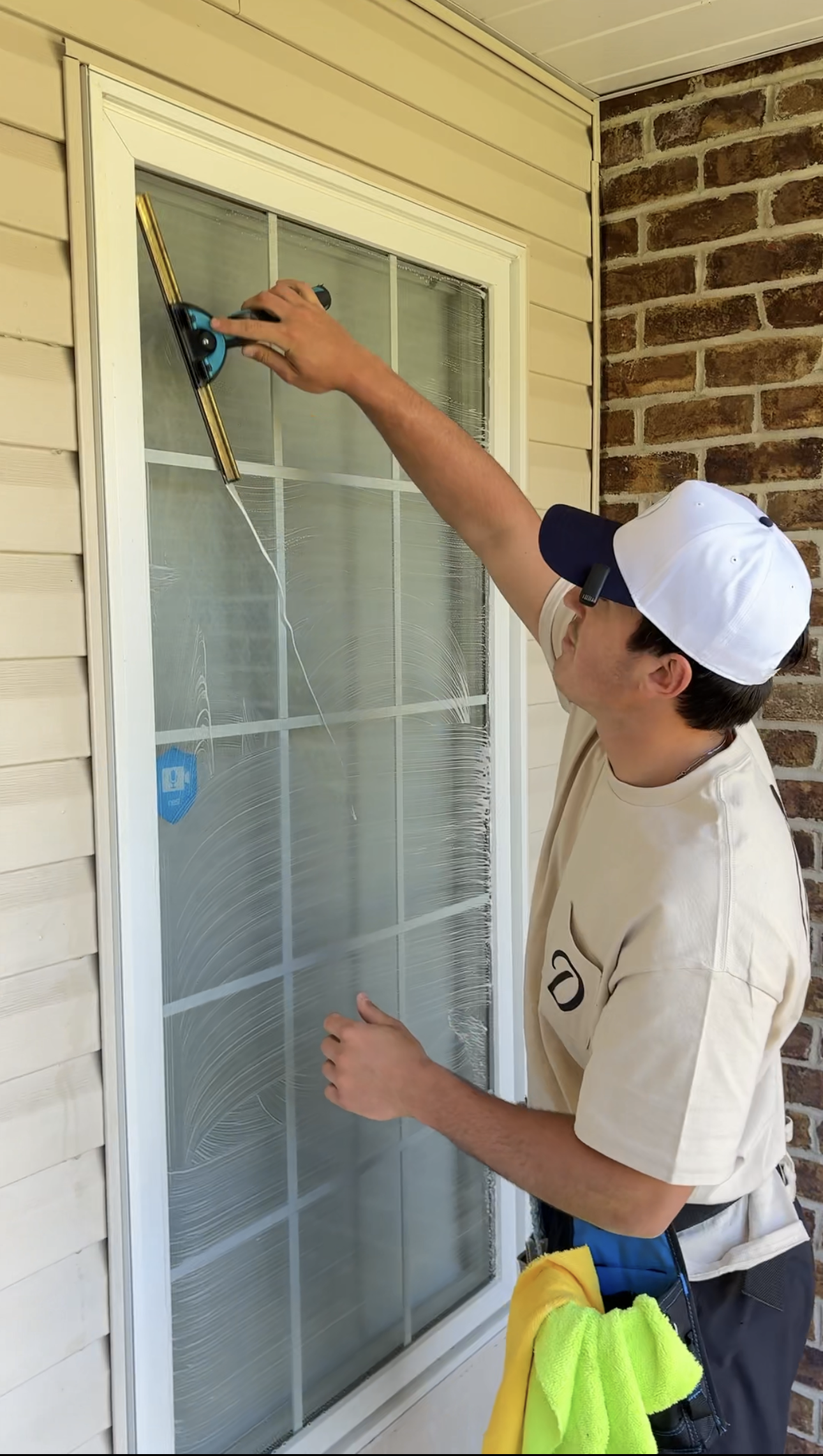 DeMoss technician squeegeeing a window to a streak-free finish